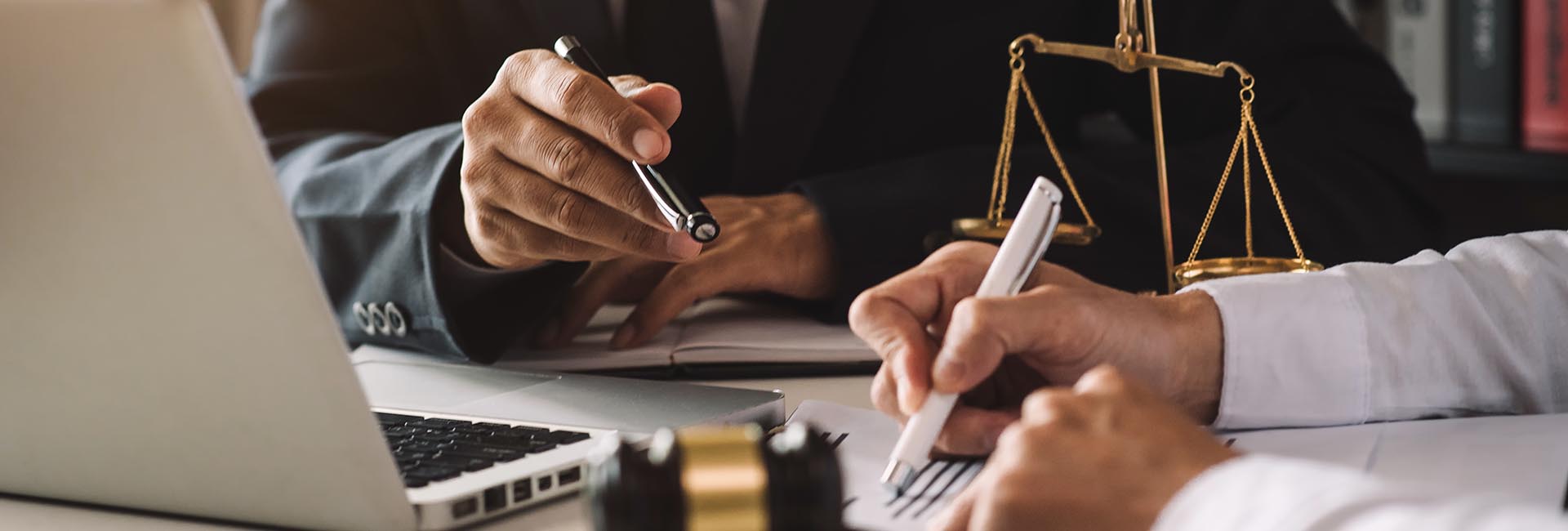 business people and lawyers discussing contract papers sitting a